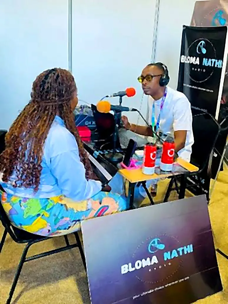 A live interview at the Bloma Nathi Radio outside-broadcast desk, Rand Show 2026